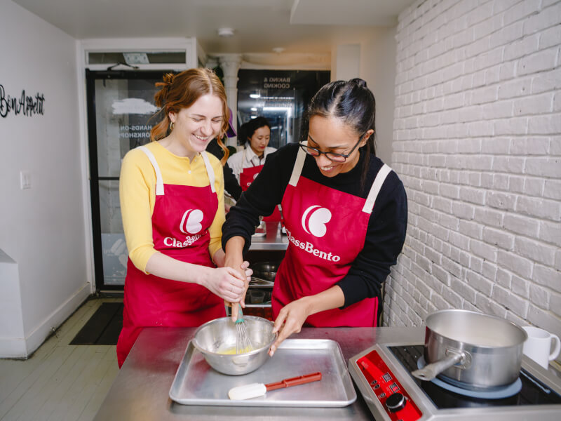 A student and teacher at a baking class